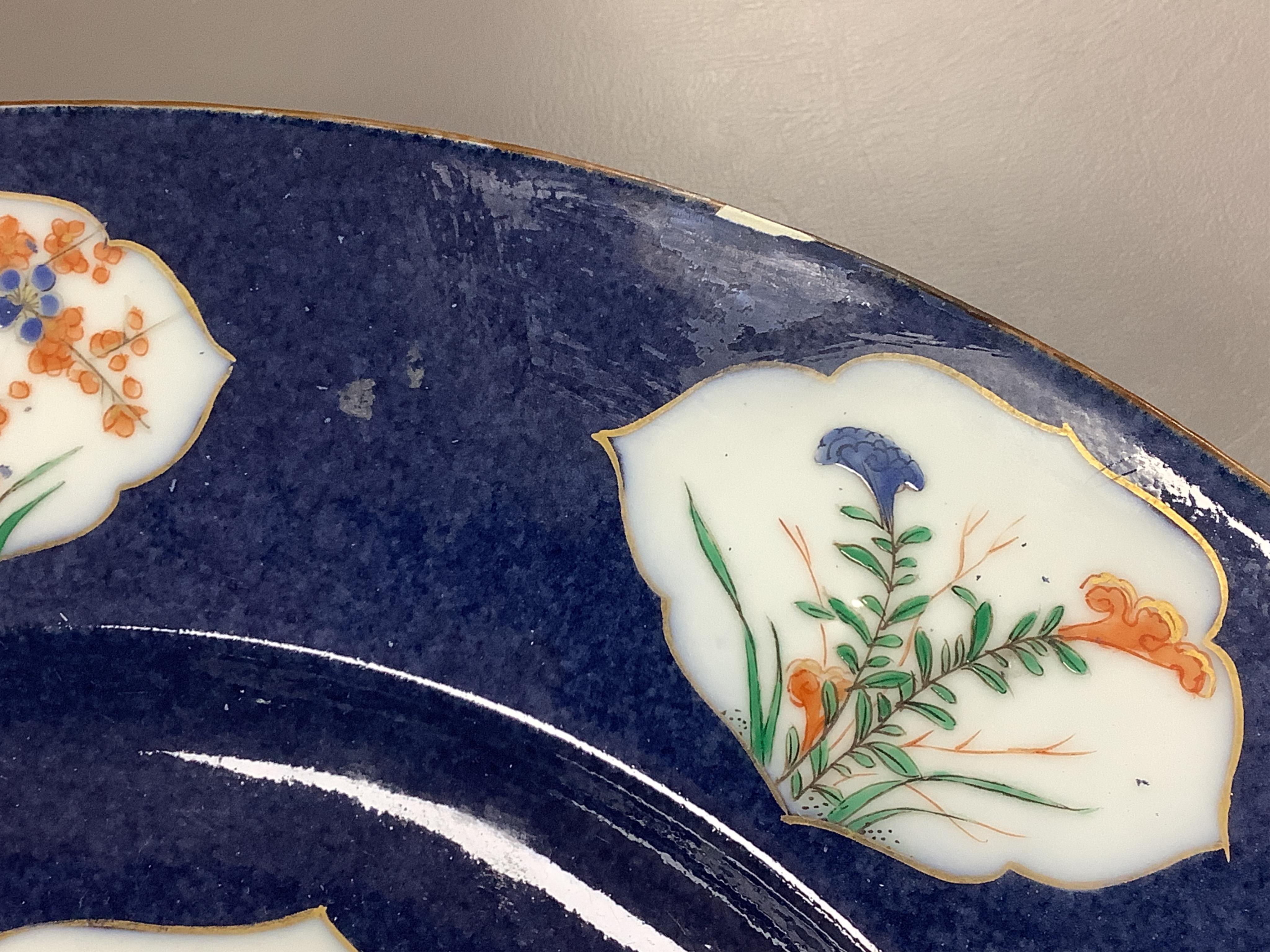 A near pair of Samson famille verte powder blue dishes in Chinese export style, each painted with a pheasant flying above blossoming branches and rocks, the border set with eight floral cartouches, underglaze blue ribbon